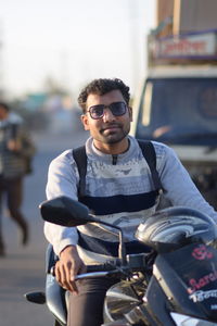 Portrait of young man sitting on motorcycle