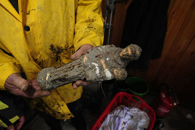 Cropped hand of man holding fish