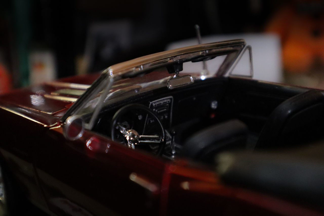 car, vehicle, land vehicle, luxury vehicle, sports car, automobile, mode of transportation, motor vehicle, transportation, performance car, close-up, indoors, selective focus, no people, supercar, arts culture and entertainment, focus on foreground, vintage car, retro styled