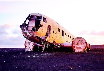 Low angle view of damaged airplane against sky