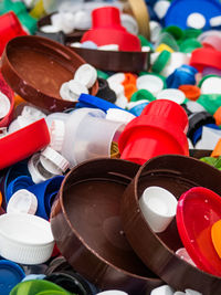 High angle view of multi colored bottle caps in factory