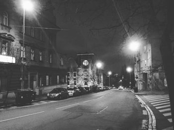 Illuminated city street at night