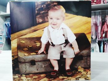 Cute boy looking away while standing in kitchen