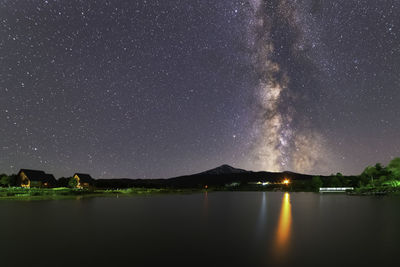 Scenic view of lake against sky at night