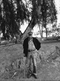 Full length portrait of man standing on tree