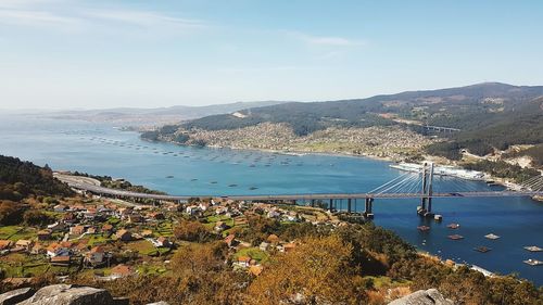 High angle view of sea and town against sky