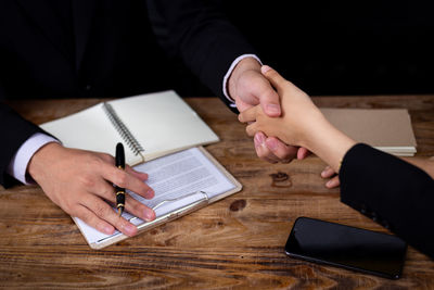 High angle view of man using mobile phone on table