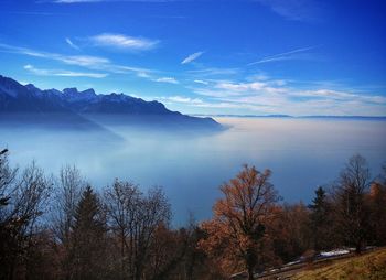 Scenic view of mountains against blue sky