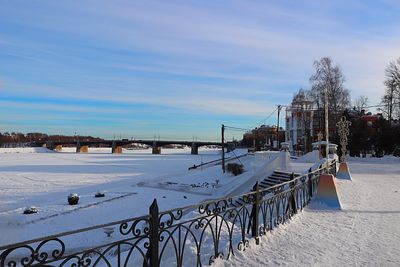 Scenic view of snow covered buildings against sky