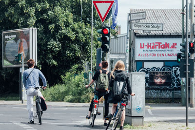 Man riding bicycle on road in city