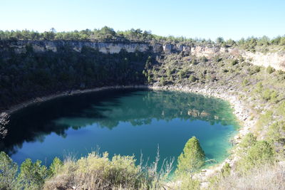 Scenic view of lake against clear blue sky