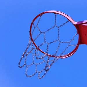 Low angle view of basketball hoop against blue sky