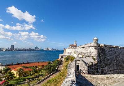 Fortress by sea against blue sky