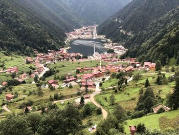 High angle view of trees and buildings against mountains