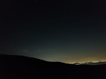 Scenic view of landscape against sky at night