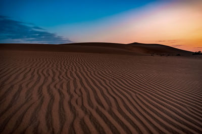 Scenic view of desert against sky during sunset