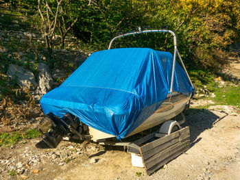 View of abandoned car on field