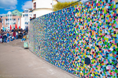 Crowd on wall against sky