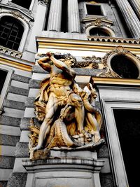 Low angle view of statue against building