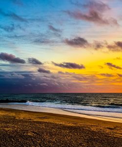 Scenic view of beach against sky during sunset