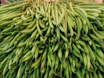 Close-up of organic green vegetable pile at market stall