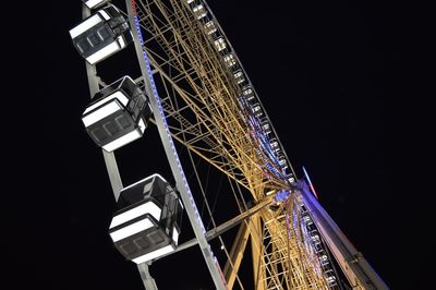 Low angle view of illuminated ferris wheel