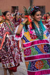 Happy young woman in traditional clothing dancing