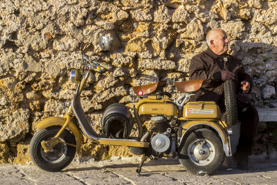 High angle view of man standing on motorcycle