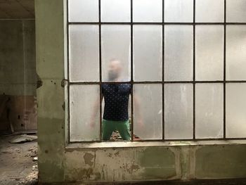 Man seen through window