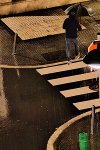 Low section of person walking on zebra crossing