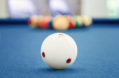 Close-up of white pool ball on table