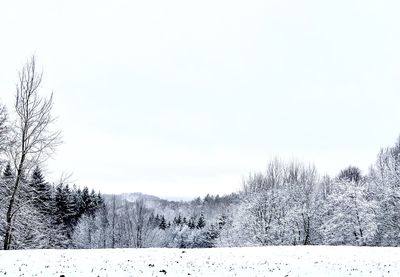 Scenic view of snow covered field against sky