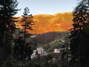 Scenic view of mountains and buildings against sky