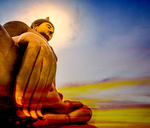 Low angle view of statue against sky during sunset