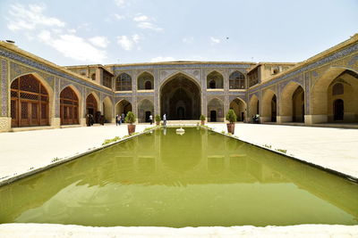 Reflection of building in swimming pool