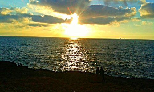 Scenic view of calm sea at sunset