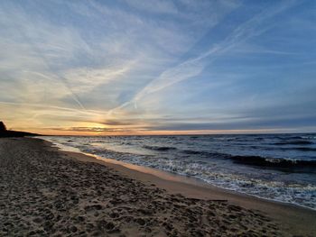 Scenic view of beach against sky during sunset