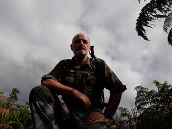 Low angle portrait of man against sky