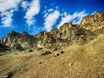 Scenic view of rocky mountains against cloudy sky