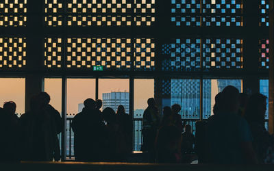 Silhouette people in corridor of building