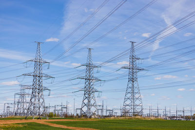 High voltage electricity pylons, transmission power lines, and distribution substation