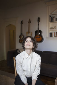 Portrait of smiling girl sitting on sofa at home