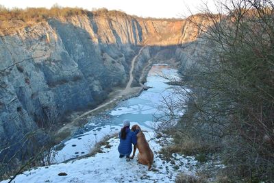 Rear view of woman on snowcapped landscape during winter