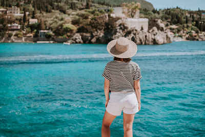 Rear view of man standing on beach