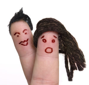 Cropped fingers with anthropomorphic face against white background