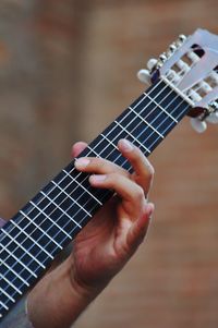 Cropped hand playing guitar