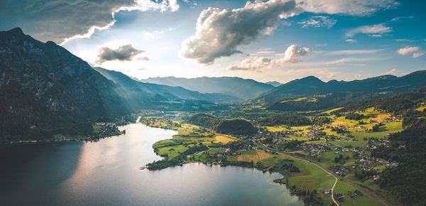 Scenic view of river and mountains against sky