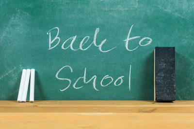 Back to school text on blackboard in classroom