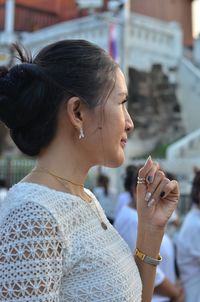 Close-up of young woman using smart phone outdoors