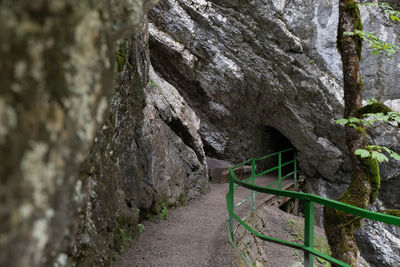 Walkway amidst rocks in sunlight